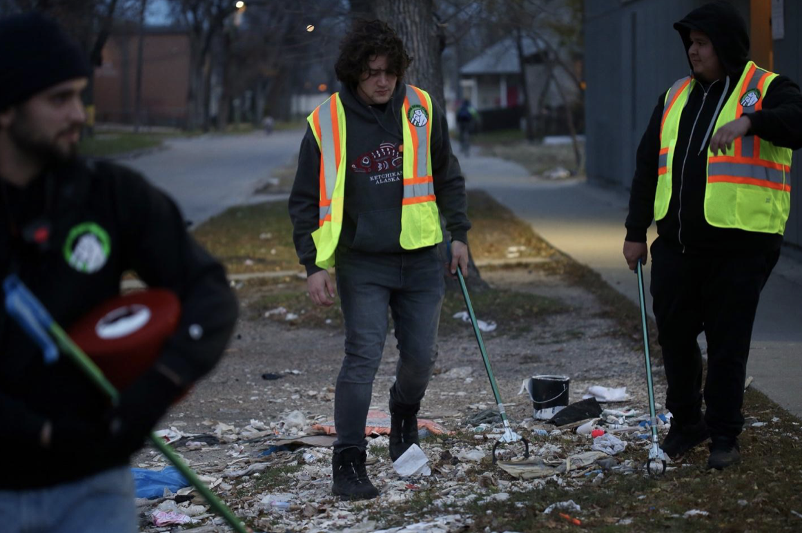 Members of the Mama Bear Clan pick up discarded needles while on patrol in Winnipeg.