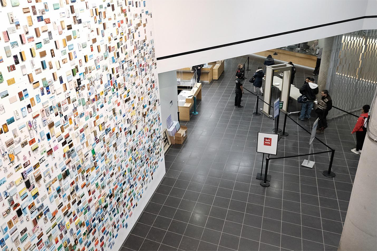 An art installation is juxtaposed against a security queue at the Millennium Library in downtown Winnipeg.
