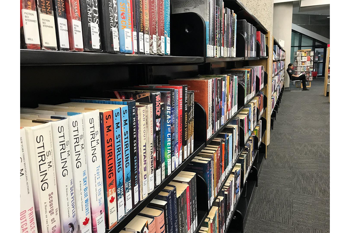 A security guard sits in the stacks at Winnipeg’s Millennium Library. 