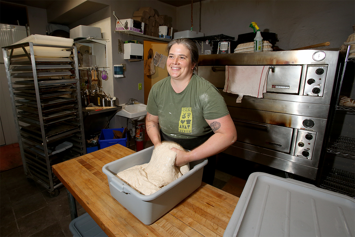 Cora Wiens kneads dough at Eadha Bread in Winnipeg