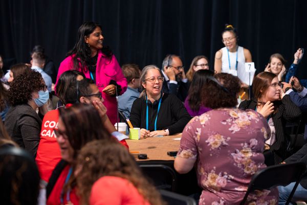Photo showing smiling people at a conference