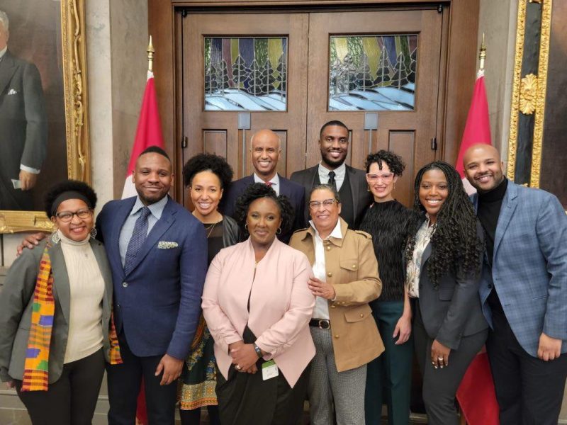 Gladys Ahovi, CEO of the Foundation for Black Communities (centre left, front row), surrounded by members of the Foundation For Black Communities board, Minister of Housing and Diversity and Inclusion, Ahmed Hussen (centre left, back row), and others.