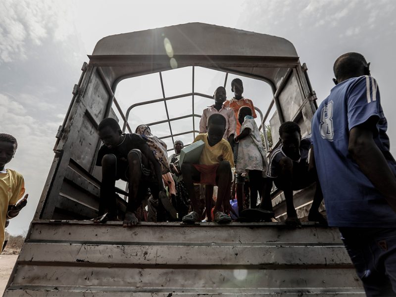 Children exit a truck in Uganda.