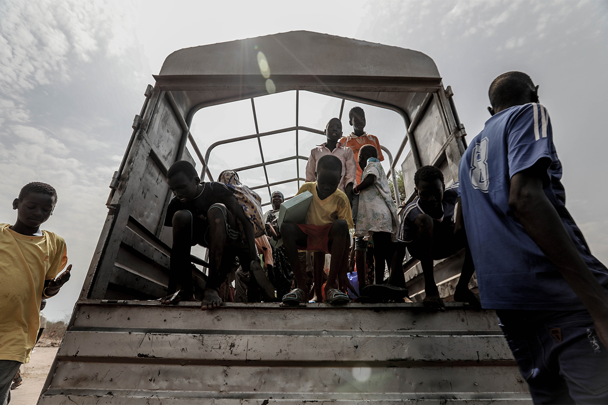 Children exit a truck in Uganda. 