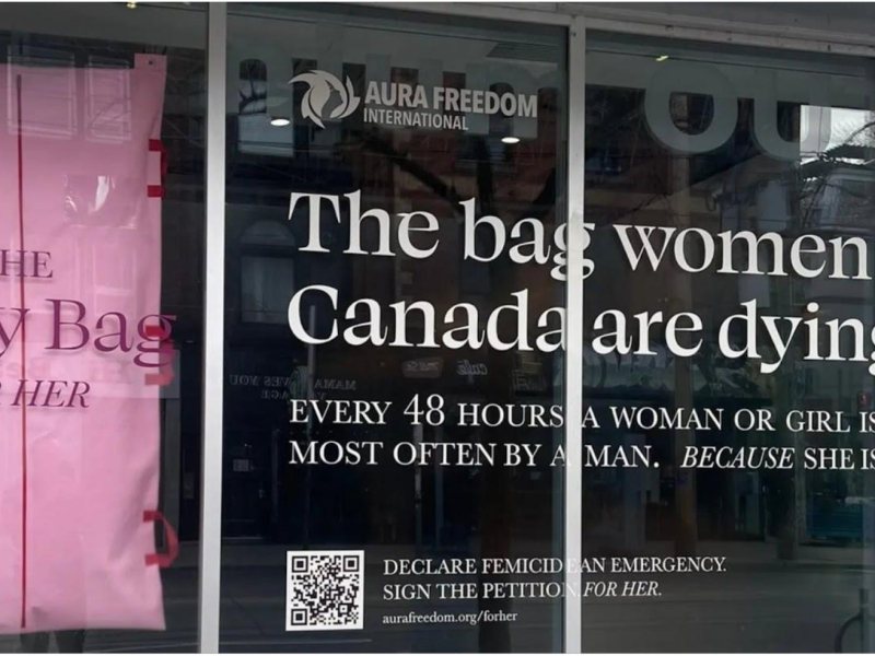 A pink body bag hangs in the window of Toronto gallery It’s OK* Studios on Nov. 24, 2023, as part of a controversial campaign by Canadian charity Aura Freedom International to raise awareness about femicide.