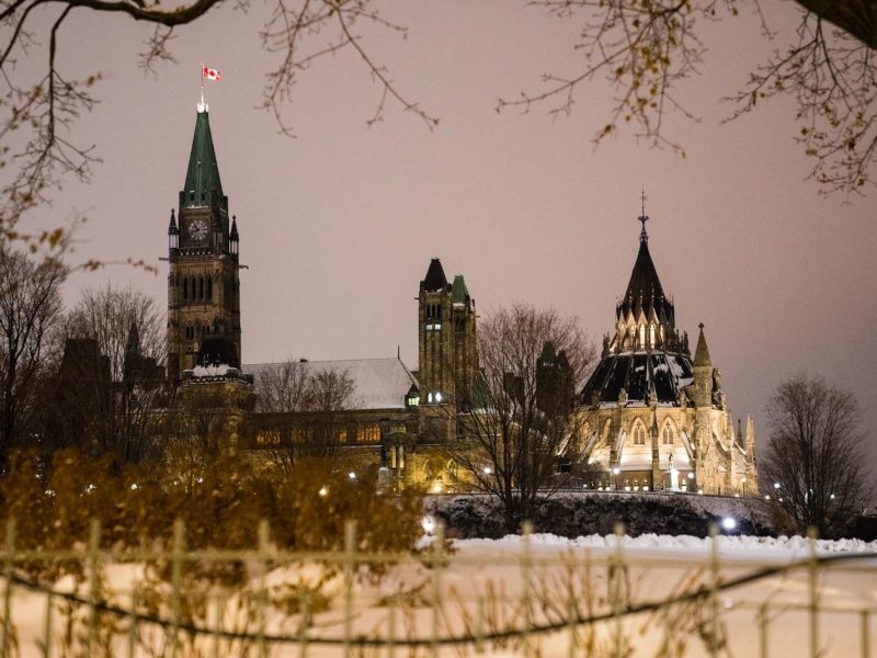 Lights illuminate Parliament Hill in Ottawa, Ont. Before the winter holidays, the Canada Revenue Agency released new guidance, which some say will help accelerate the flow of money to non-profits and grassroots groups. (Naveen Kumar / Unsplash)