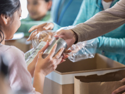A child is receiving food at a food bank.