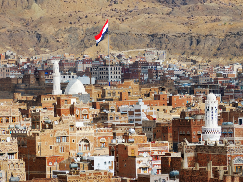 A flag flies in Sanaa, Yemen, inhabited for more than 2,500 years. The OId City of Sanaa is a UNESCO World Heritage City but has been destroyed by civil war.