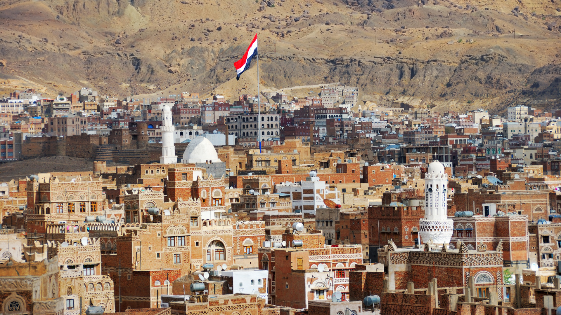 A flag flies in Sanaa, Yemen, inhabited for more than 2,500 years. The OId City of Sanaa is a UNESCO World Heritage City but has been destroyed by civil war.