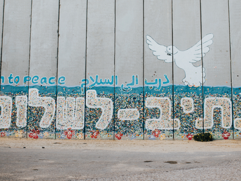 Photo of Path to Peace is written in English, Arabic and Hebrew on a portion of the wall separating Gaza from Israel.