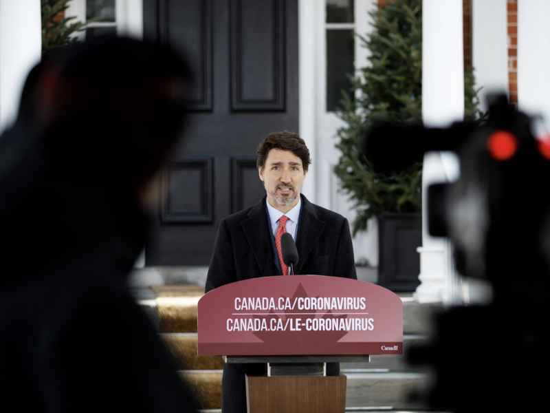 Canada's Prime Minister Justin Trudeau stand at a podium.