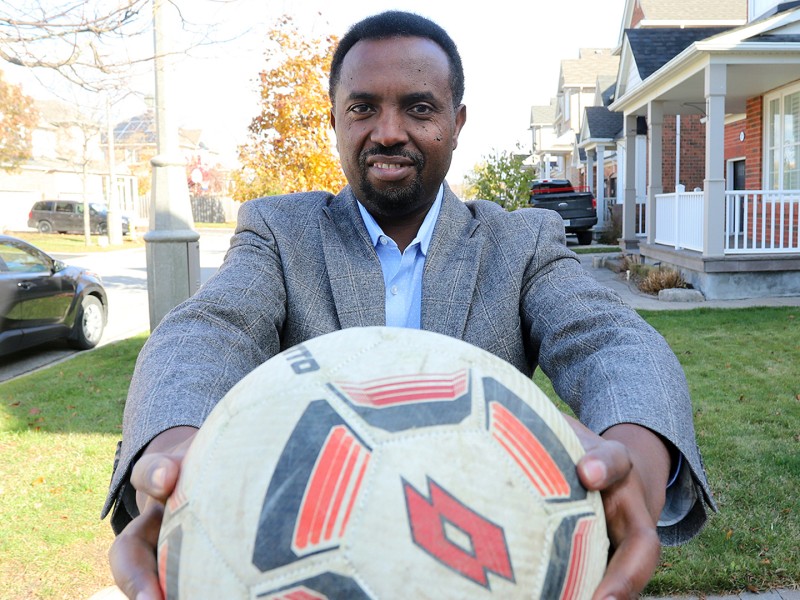 Photo of Jean Claude Munyezamu holding a soccer ball