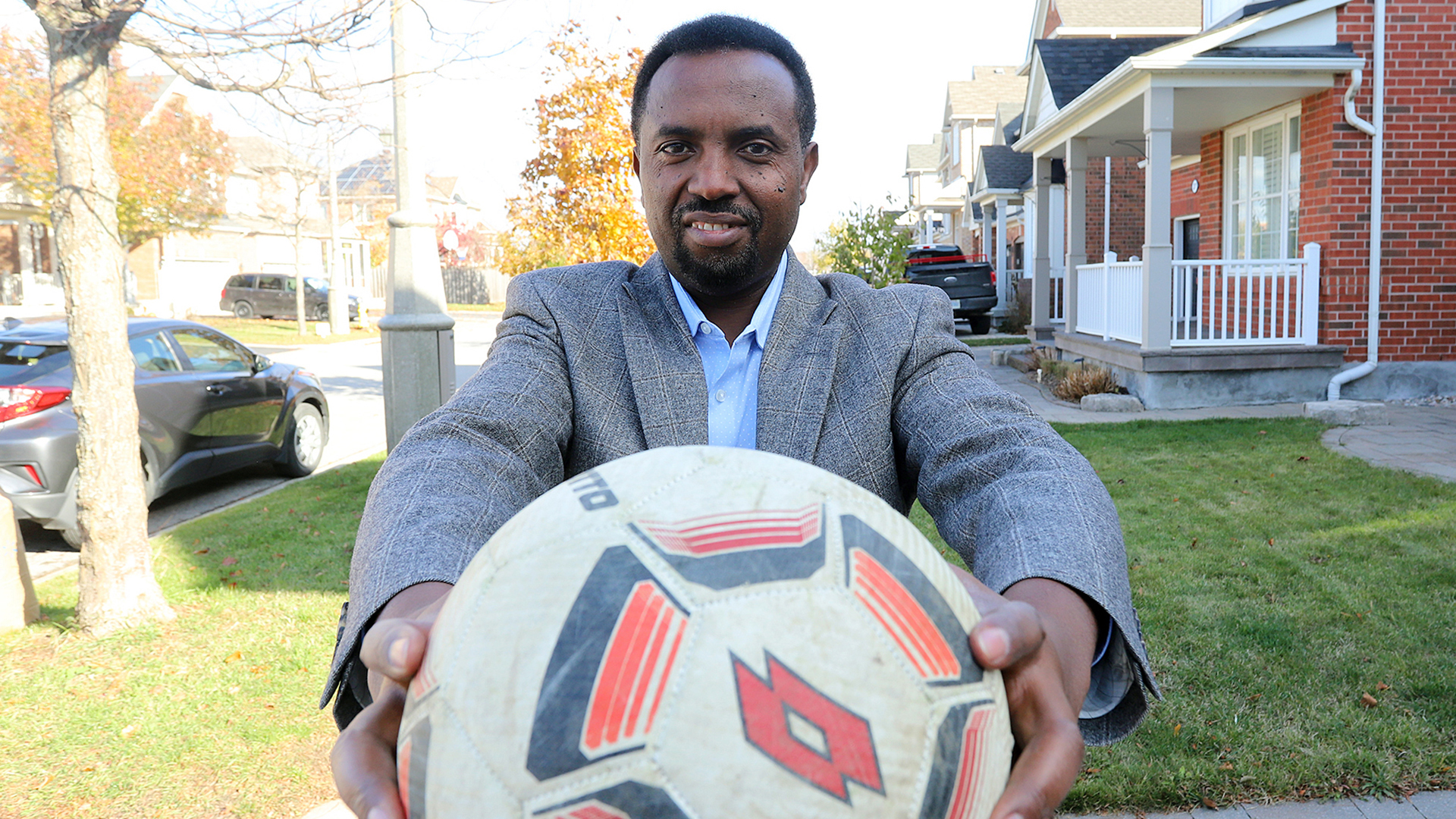 Photo of Jean Claude Munyezamu holding a soccer ball